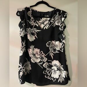 Black and white sleeveless blouse.